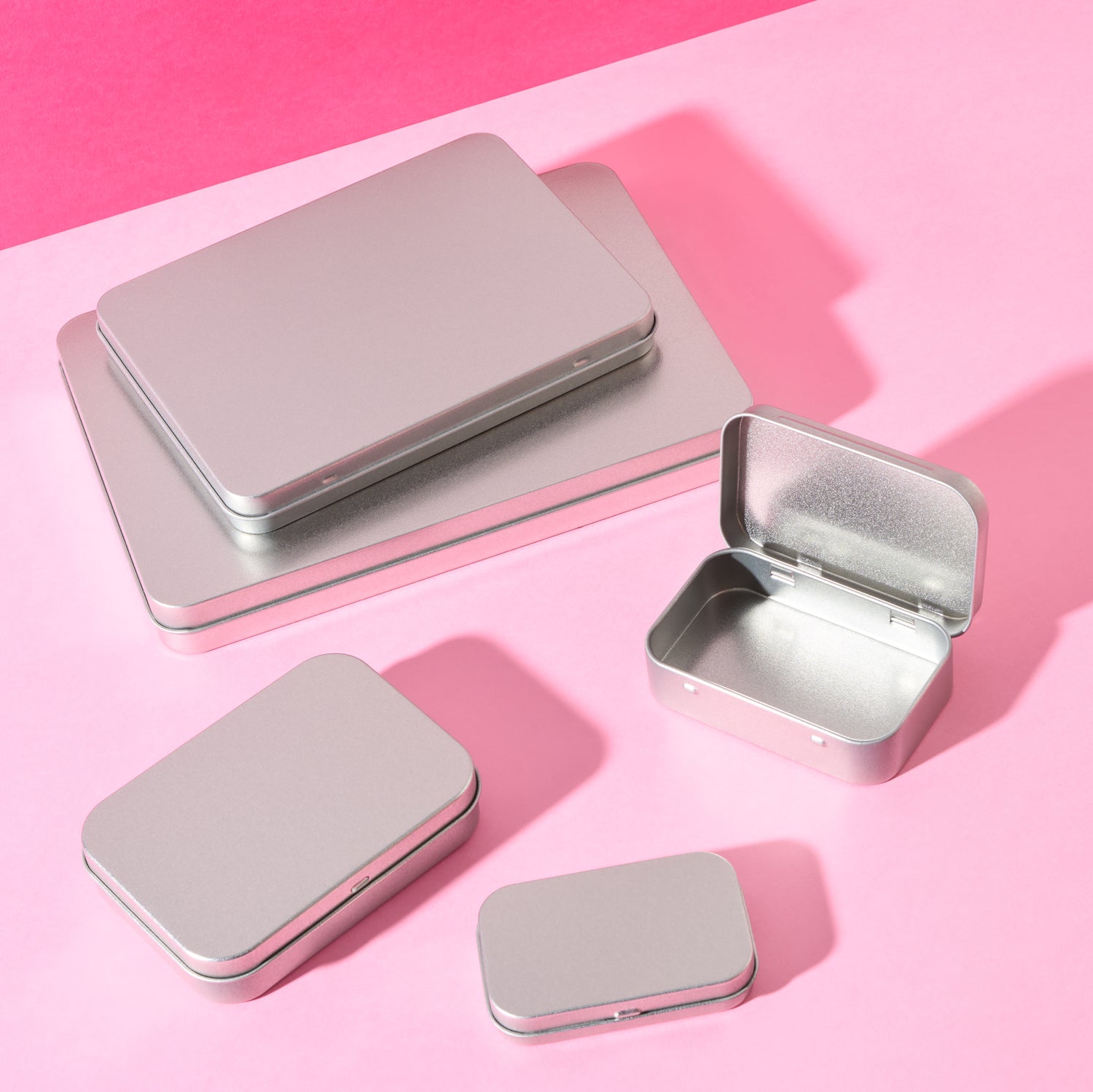 A collection of different sized rectangular stationery tins.