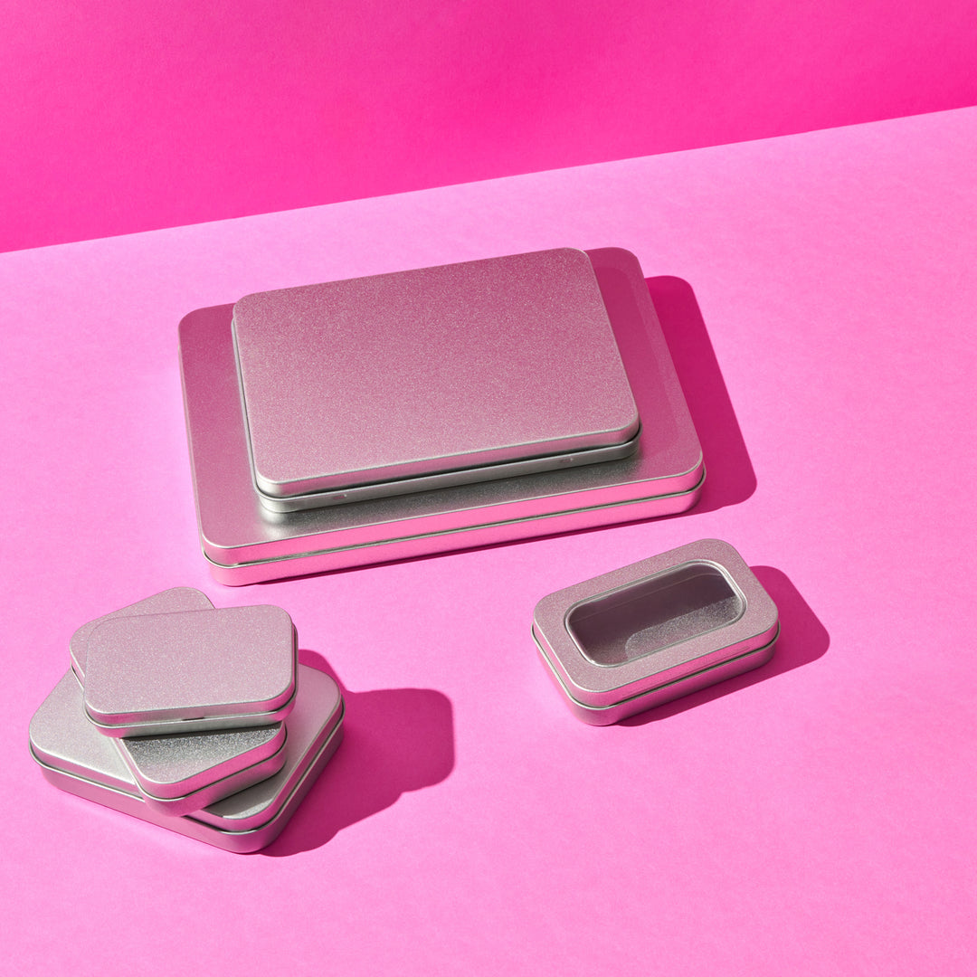 A collection of different sized rectangular stationery tins.