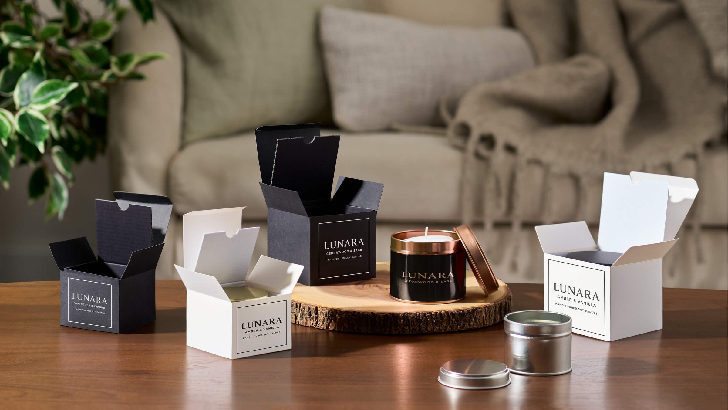 Selection of gift boxes with candle tin packaging in living room